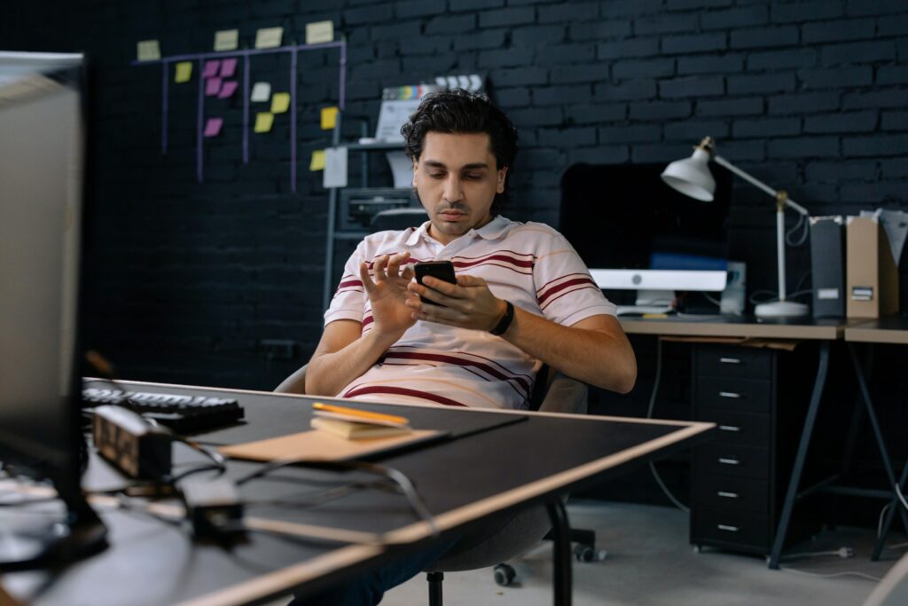 Toxic Employee siting at desk avoiding work.